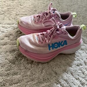 Hoka Shoes with Green Soles and Pink Accents